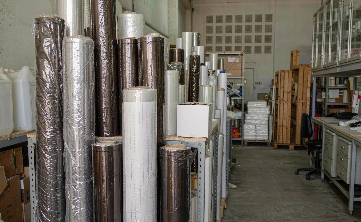 Wall sticker roll store: rolls stood upright by the stack awaiting cutting and dispatch